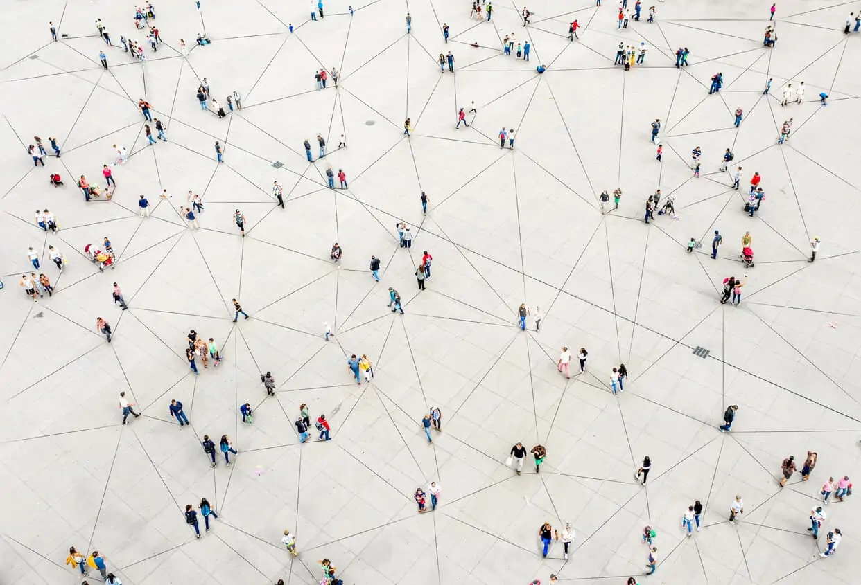 Aerial view of people walking on what appears to be a networking grid
