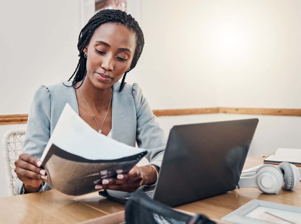 woman looking at papers on a table