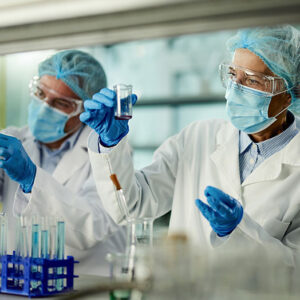 Medical scientists conduct tests in a lab