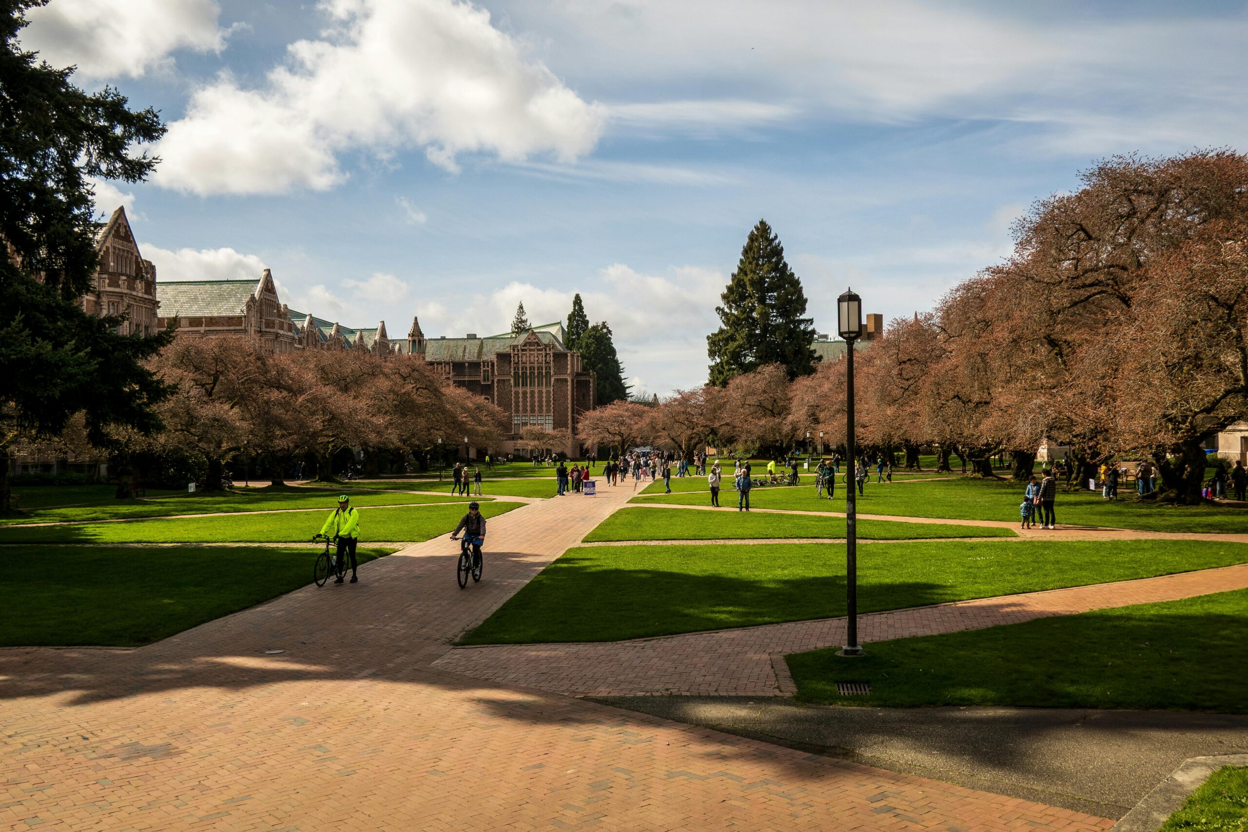 University of Washington quad with students walking and on bicycles.