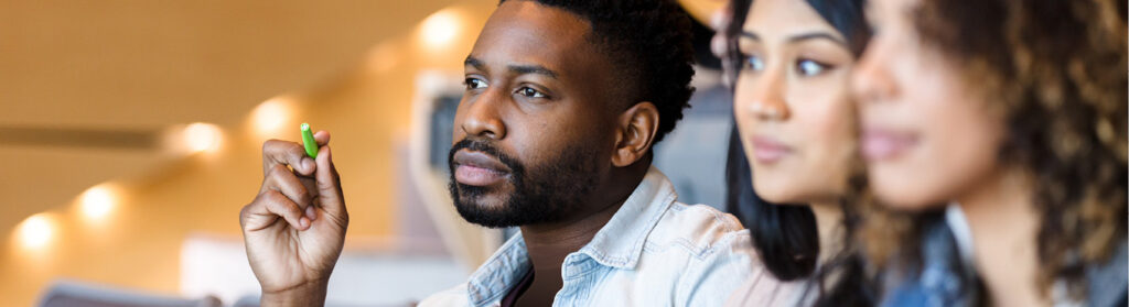 International students listen attentively in a lecture hall.