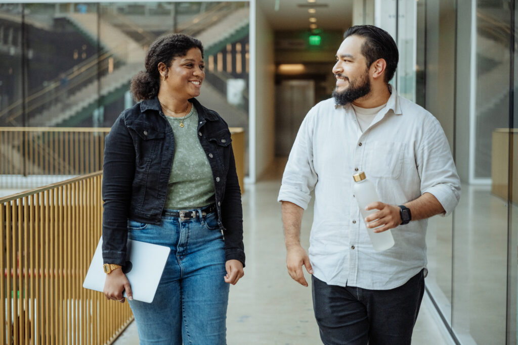 Group of students at university hall using laptop, African American and Hispanic students studying together