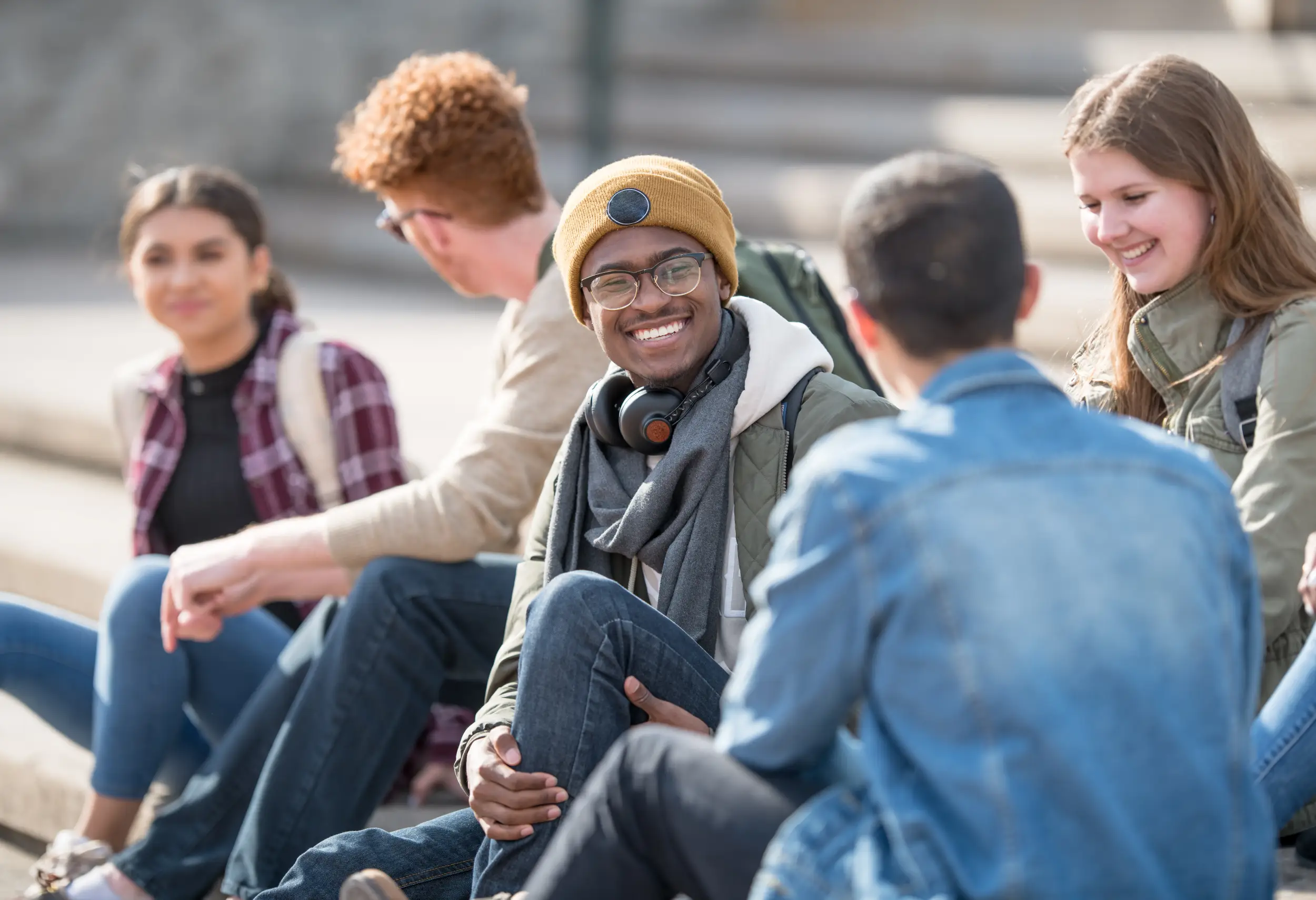 International students sitting on steps at University