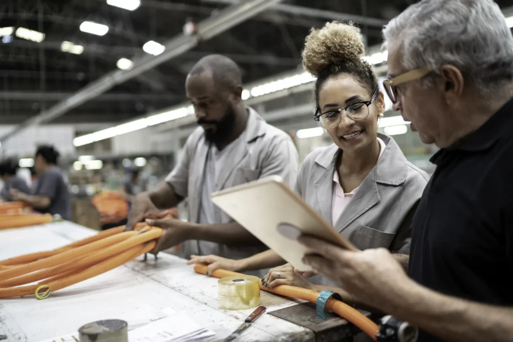 Diverse factory workers work together to get the job done.
