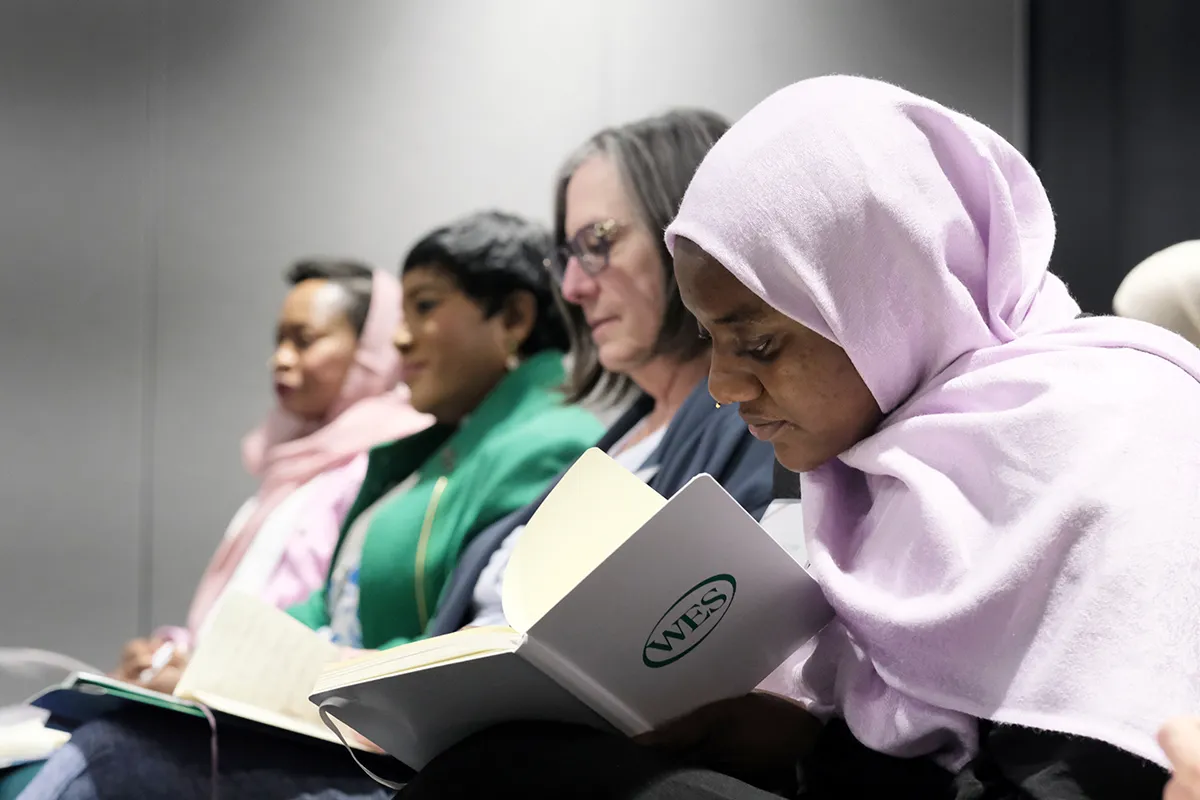 Participants at a WES gathering listen in the audience