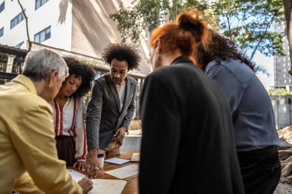 group of people gathered around a table in collaboration