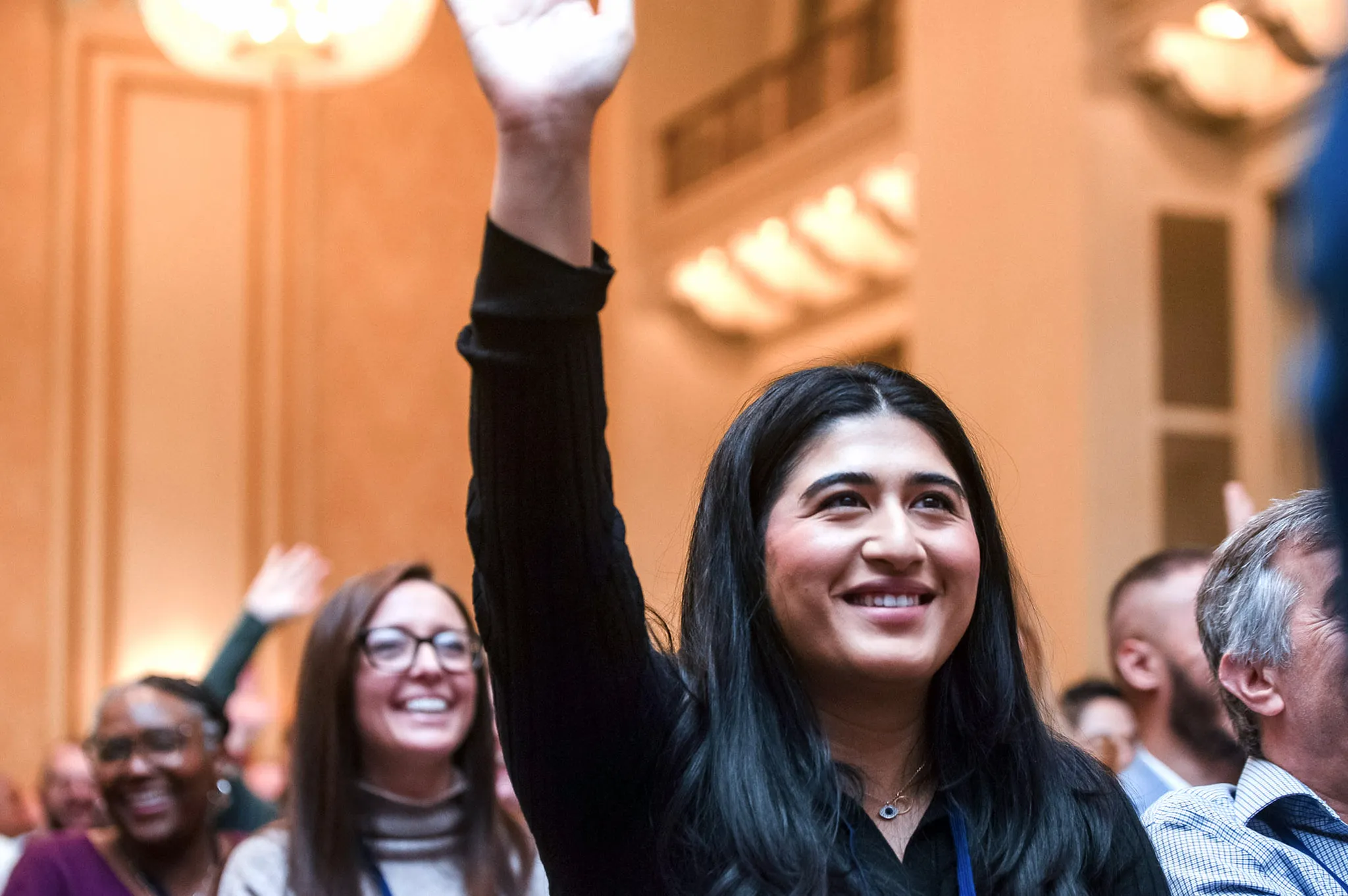 A WES employee raises her hand at the WES 50th anniversary retreat